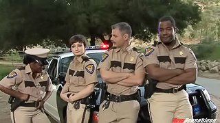 Pretty police woman attracted to a black male counterpart getting cozy at the station