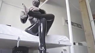 Hooded rubber woman in latex catsuit and ballet boots