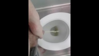 Wow, a hot guy pissing slowly, letting his cock drip!