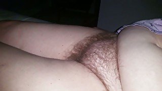 Lusty big breasted lady exposed her super bushy pussy while lying on bed