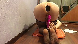 Plugged Sissy in fishnets plays with a vibrator and drinks her cum