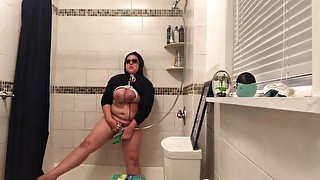 Masturbating with shower head and small broom