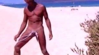 Tanned guy on beach in tiny string thong (temporarily!)