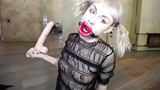 Russian girl fucks herself in the throat with a rubber dick