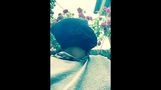 Masked ebony bbw smoking outside in garden and rubbing pussy