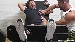 Tied up guy moans with pleasure from getting his feet tickled