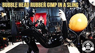 Bubble Head Rubber Gimp in a Sling - Heavy Rubber Dominatrix strap-on teaser