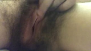 Hair pussy masturbates up close