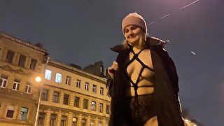 Blonde Walking In The Street With Ropes Under Her Coat