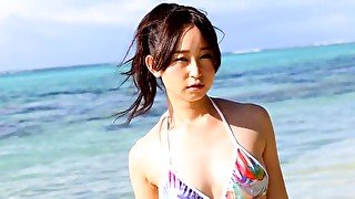 Lovely Asian girl Yumi Ishikawa swims in the ocean