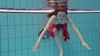 Red Dressed teen 18+ swimming with her eyes opened