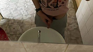 Pissing in a public toilet in the sink, filming through the mirror