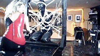 Latex slave tied up in bondage