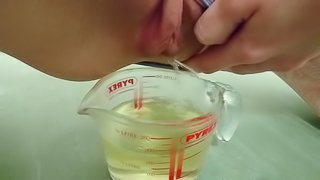 pee in measuring cup close up