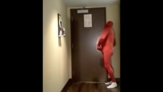 red morphsuit jerking off at hotel room door