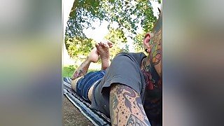 Female Freak With A Tattooed Face &amp; Body Exposing Sexy Soles In The Background