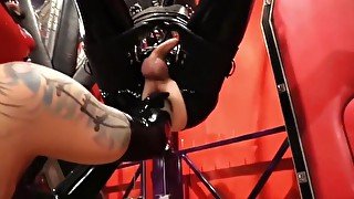 Red masked rubber mistress fucks latexslave ass