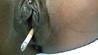 Big black shiny pussy smoking a cigarette on webcam