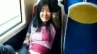 Asian milf rubs her clit on a train.