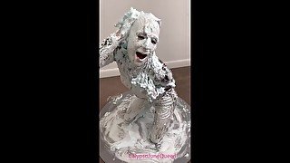 Milf in PVC Catsuit & heels covers her entire body with shaving foam pies