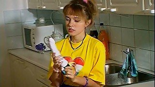 Thrifty blondie switches from washing dishes to polishing her twat with a dildo