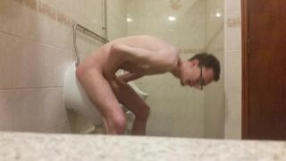 Very skinny teen masturbates in public bathroom urinal