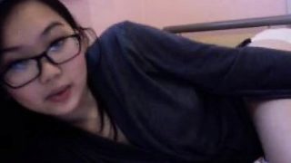 Young and pretty Asian nerd offers a sexy sneak peek of her