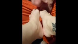 Watch a big cock get a foot job