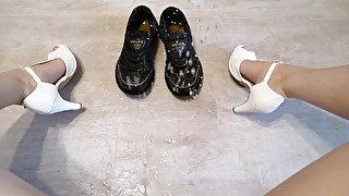 Naughty woman in white shoes soaked men's shoes