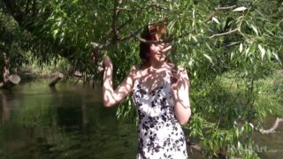 Adorable redhead teen takes a naked dip in a river