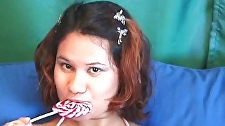 Curvaceous ginger babe sucks lollipop and masturbates