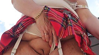 Tartan skirt flashing outdoors