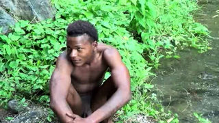 Brown soldier strips naked by the stream