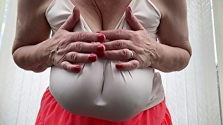 Mature Sally huge boobs in a tight white top