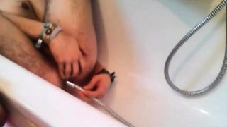 Bi-guy using shower head, squirting water, enema