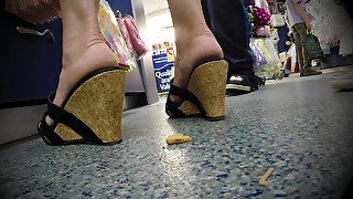 Naughty Milf Crushing Some Junk Food With Her Sexy Shoes In Public