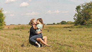 Beautiful Teen Couple in Love Passionately Kissing on the field