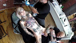 Sascha plays with Amber Luke while she gets tattooed