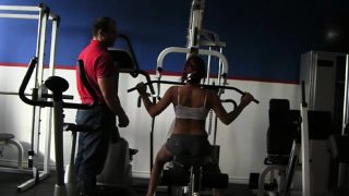 Trainer helps a hottie work out on the equipment before he nails her