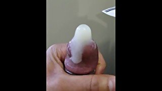 Jacking off moaning busting a hard nut in a condom