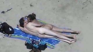 Sexy girlfriend on the beach gives handjob to her partner