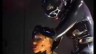 Two sexy lesbians full encased in latex suits have fun in her rubber skins - Part 2