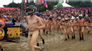 Wild folks wearing a helmet run naked on a cross track