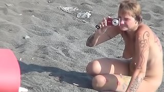 MILF nudist is getting naked on the beach