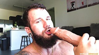 Solo gay dude sucks a massive dildo and inserts it in his ass