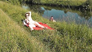 Nudist beach. Public nudity. Naked in public. Sexy MILF without panties and bra sunbathes naked Nude