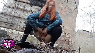 Desperate Redhead peeing in the forest ruins.