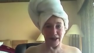 A fresh old woman teases the camera after a shower