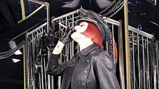 Mistress Tokyo Smoking Cigarette In Leather, Gloves And Muir Cap