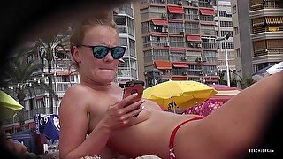 Hidden cam spies on a redhead at the beach